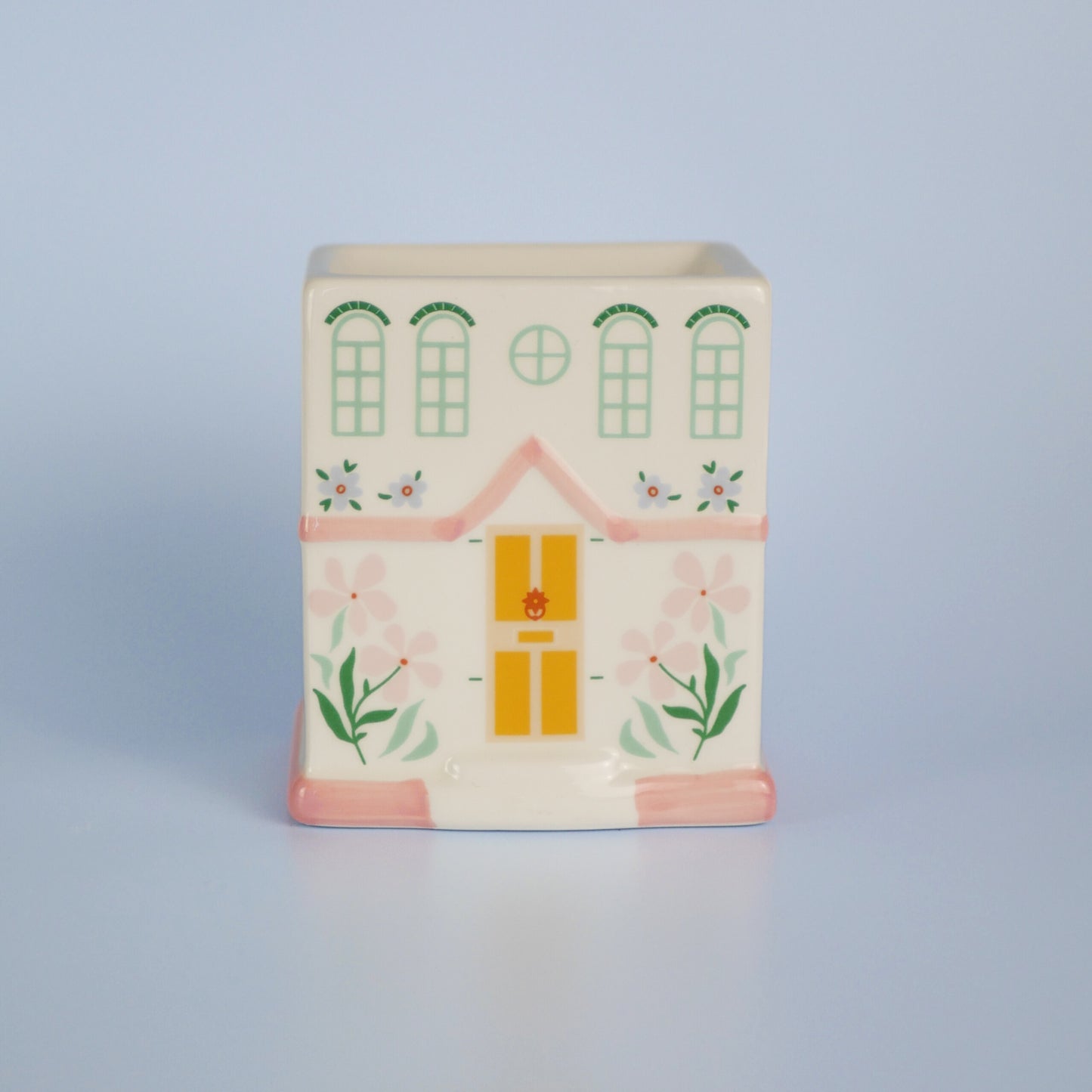 A pastel townhouse wax melt burner with the lid off