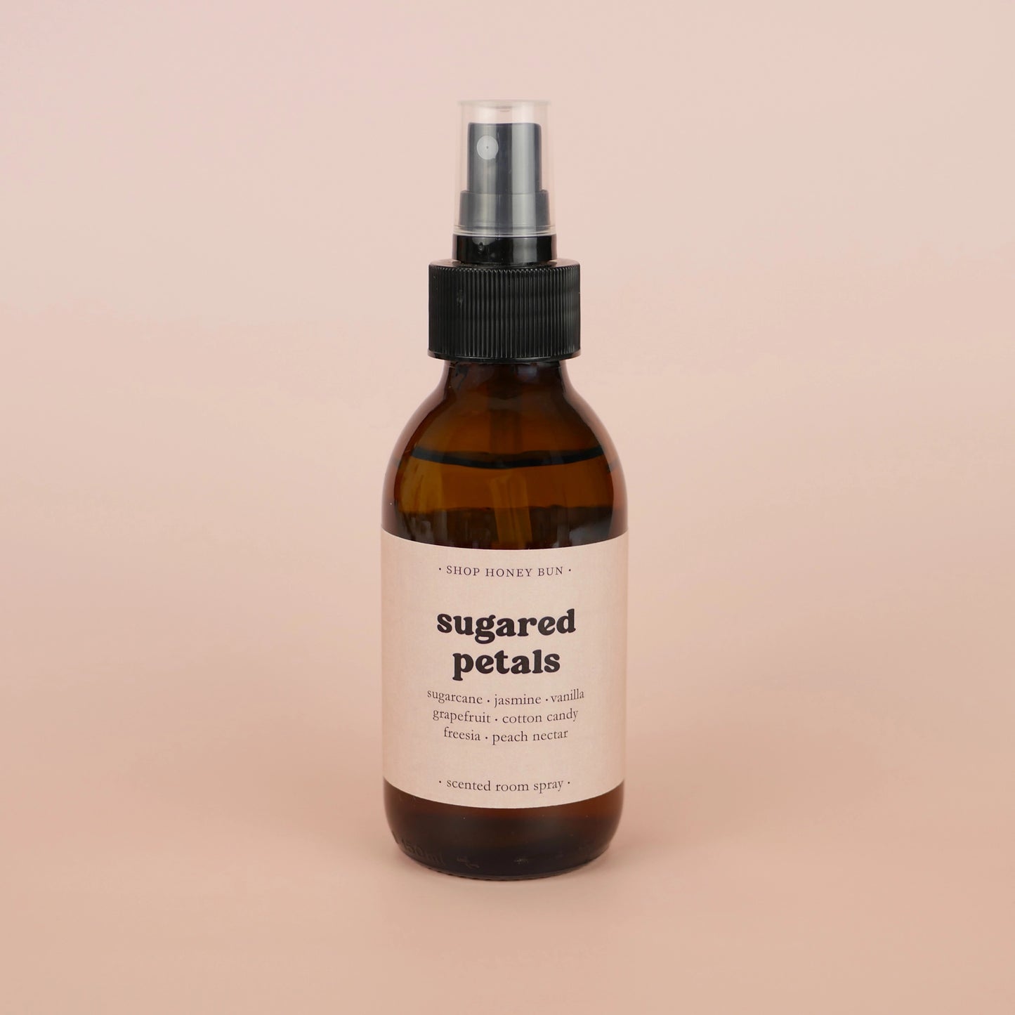 An sugared petals scented room spray in an amber glass spray bottle
