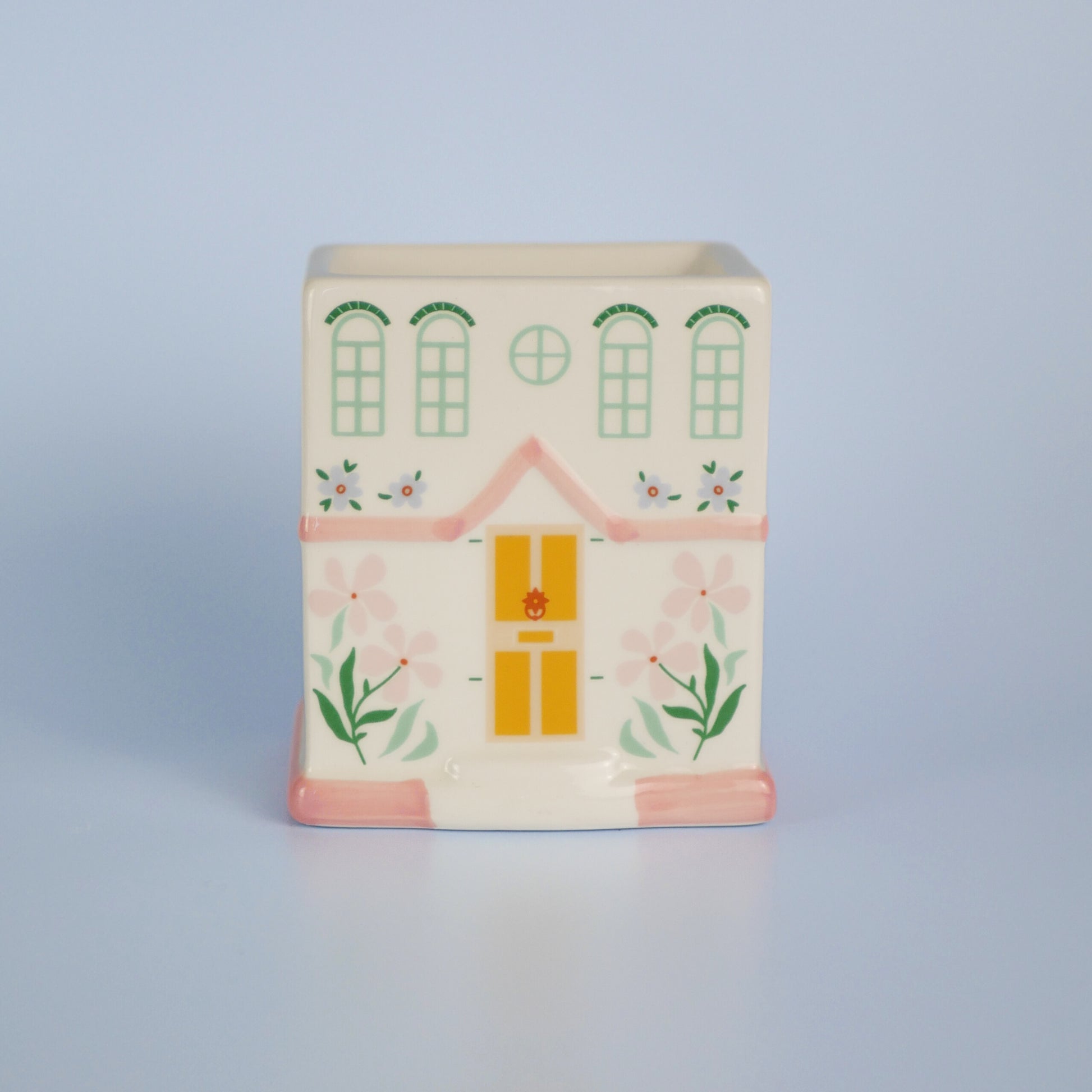 A pastel townhouse wax melt burner with the lid off