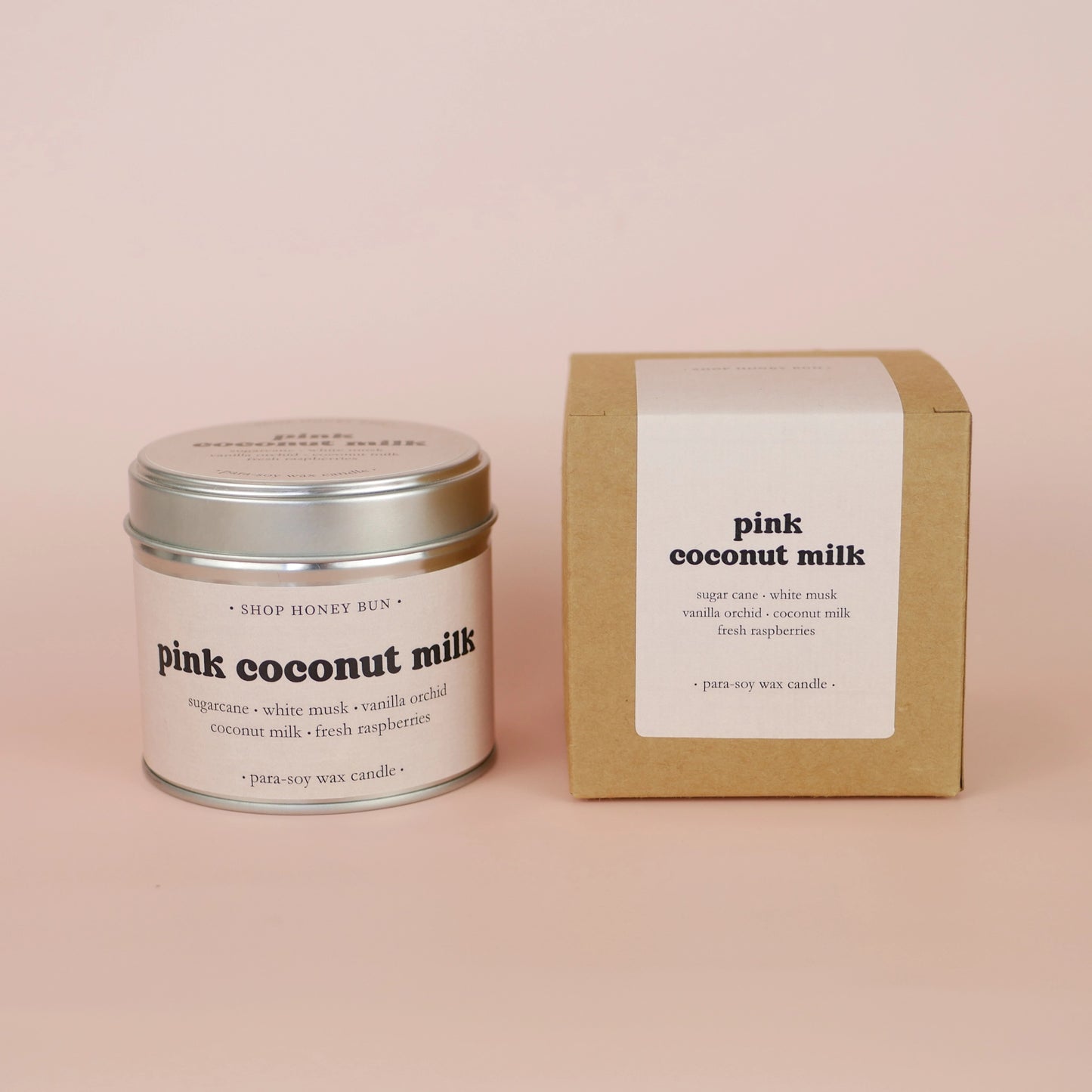 A 30 hour burn time pink coconut milk scented tin candle next to a brown kraft box with a pale pink paper label