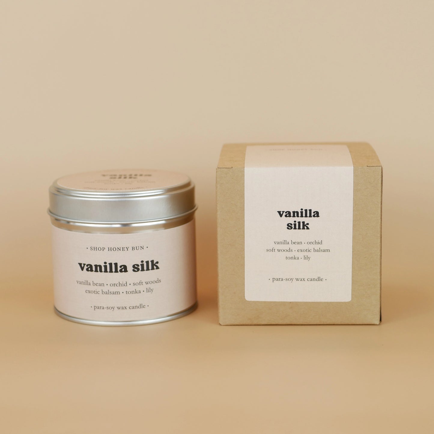 A 30 hour burn time vanilla silk scented tin candle next to a brown kraft box with a beige paper label

